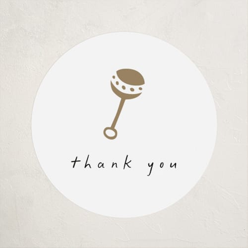 This is a cotton baby shower favor labels with standard by Stacy Maalouf called gold rattle printing on uncoated sticker paper in sticker