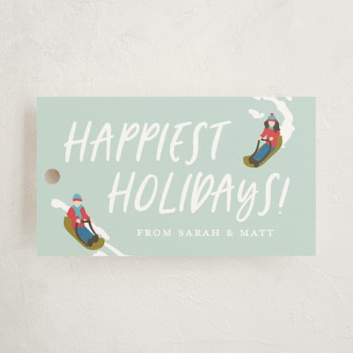 This is a mint gift tags by Meggy Masters called sledding scene printing on signature in tag
