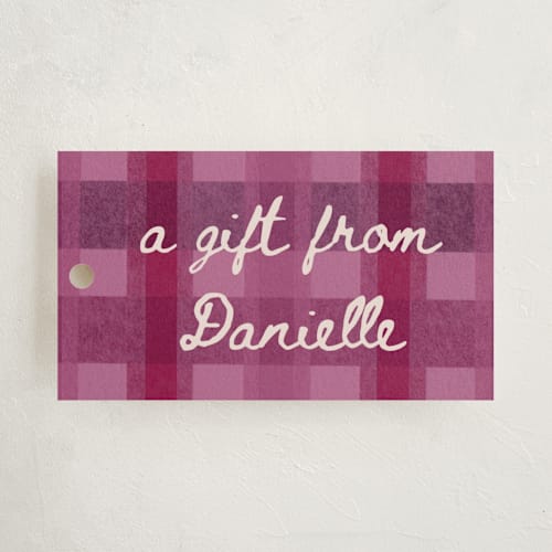 This is a raspberry gift tags with standard by Carrie Moradi called cozy checked plaid printing on signature in tag
