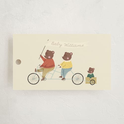 This is a cream baby shower favor tags with standard by Kiersten Garner called baby makes three printing on signature in tag