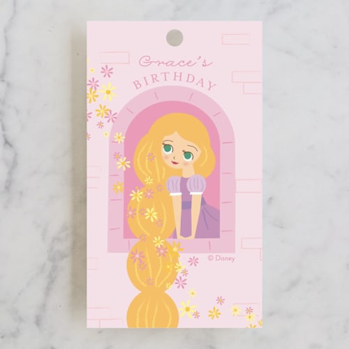 This is a strawberry kids gift tags with standard by Angela Thompson called disney's rapunzel tower printing on signature in tag
