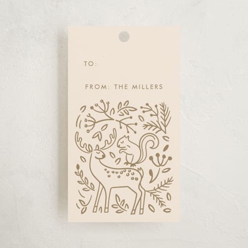 This is a golden gift tags by Teju Reval called enchanted holiday printing on signature in tag