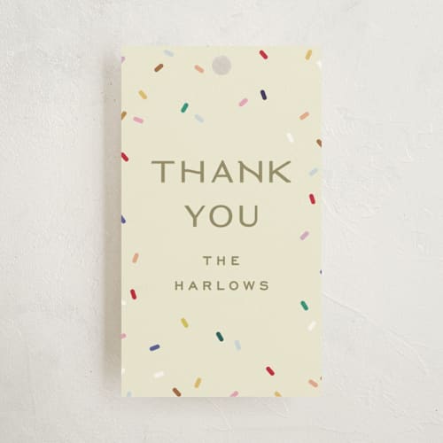 This is a cream baby shower favor tags with standard by Ellen Schlegelmilch called tiny bold sprinkles printing on signature in tag