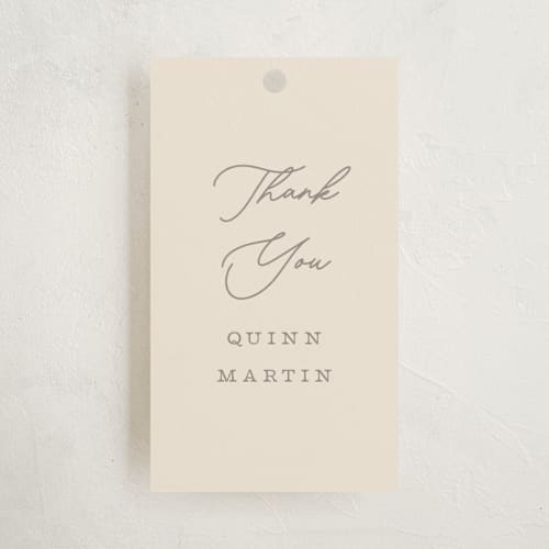 This is a vanilla baby shower favor tags with standard by Pixel and Hank called swiggle printing on signature in tag