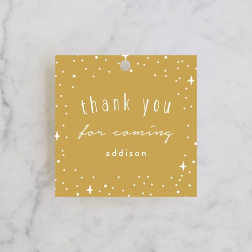 This is a gold kids gift tags with standard by Angela Garrick called pixie printing on signature in tag