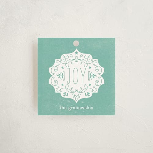 This is a dusty blue gift tags by Bonjour Paper called festive joy printing on signature in tag