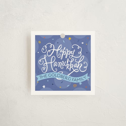 This is a periwinkle gift tags by Laura Bolter called joyful hanukkah printing on signature in tag