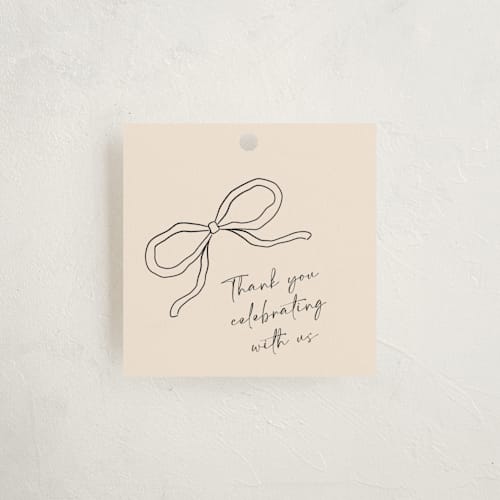 This is a linen baby shower favor tags with standard by Joyce Pinheiro called tied with love printing on signature in tag