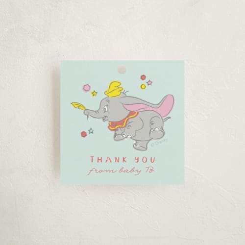 This is a baby blue baby shower favor tags with standard by Kanika Mathur called disney's baby dumbo printing on signature in tag