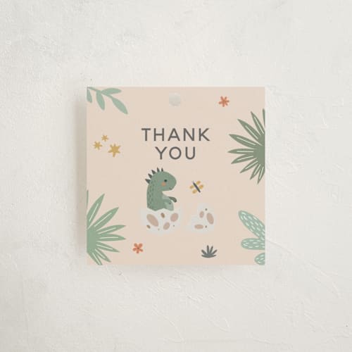 This is a tan baby shower favor tags with standard by Britt called baby dino printing on signature in tag