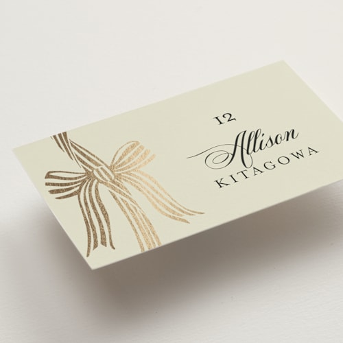 This is a champagne wedding place cards with foil pressed by Chris Griffith called all tied up printing on signature in placecard
