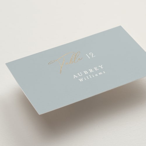 This is a dusty blue wedding place cards with foil pressed by Angela Thompson called delicacy printing on signature in placecard