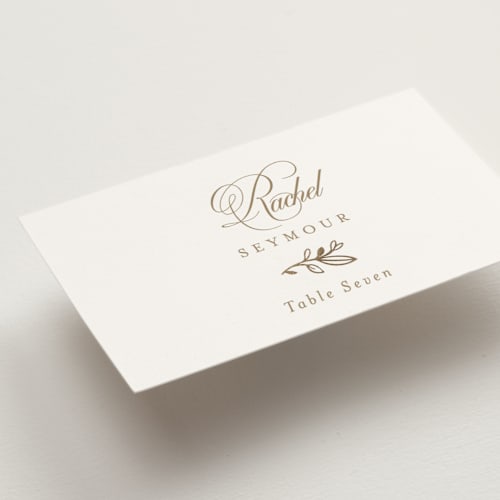 This is a ivory wedding place cards with foil pressed by Mansi Verma called gold crest printing on signature in placecard