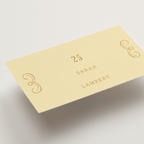 This is a butter wedding place cards with standard by Nazia Hyder called vintage label printing on signature in placecard