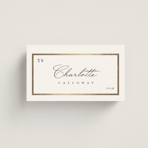 This is a ivory wedding place cards with foil pressed by Lucrecia Caporale called regal frame printing on signature in placecard