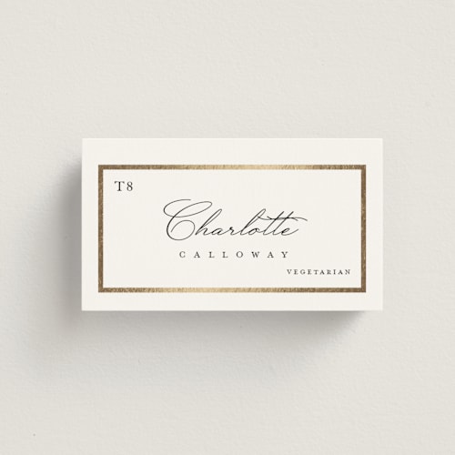 This is a ivory wedding place cards with foil pressed by Lucrecia Caporale called regal frame printing on signature in placecard