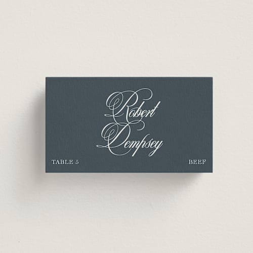 This is a navy wedding place cards with standard by Megan Davis called calligraphy printing on signature in placecard