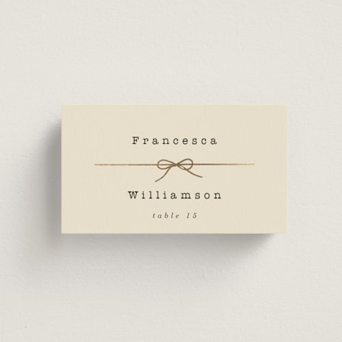 This is a ivory wedding place cards with foil pressed by Baumbirdy called bow tie printing on signature in placecard