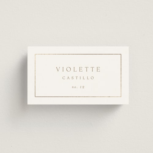This is a golden wedding place cards with foil pressed by Kelly Schmidt called framed monogram printing on signature in placecard