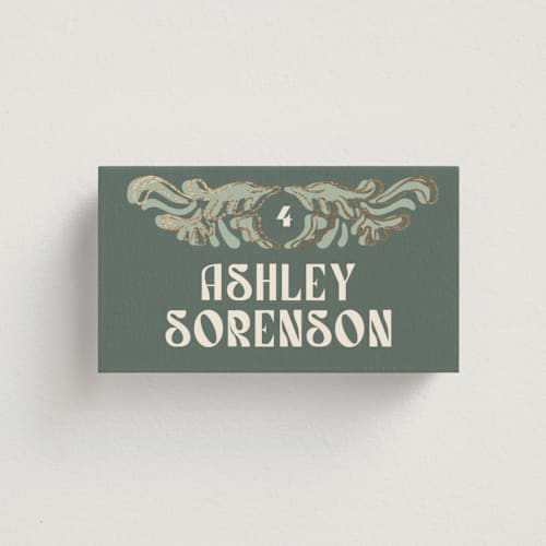 This is a sage wedding place cards with foil pressed by GeekInk Design called nouveau frame printing on signature in placecard
