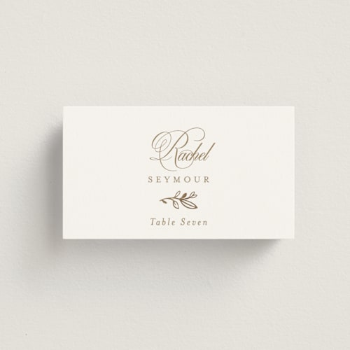 This is a ivory wedding place cards with foil pressed by Mansi Verma called gold crest printing on signature in placecard