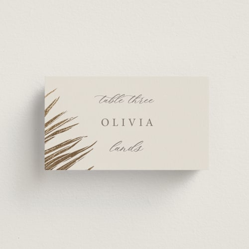 This is a sand wedding place cards with foil pressed by Melinda Denison called gilded palm printing on signature in placecard