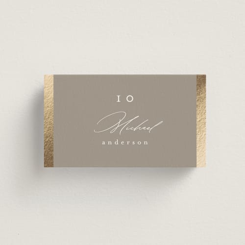 This is a khaki wedding place cards with foil pressed by Nicole Walsh called surround printing on signature in placecard