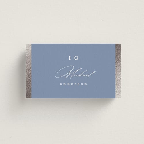 This is a cornflower blue wedding place cards with foil pressed by Nicole Walsh called surround printing on signature in placecard