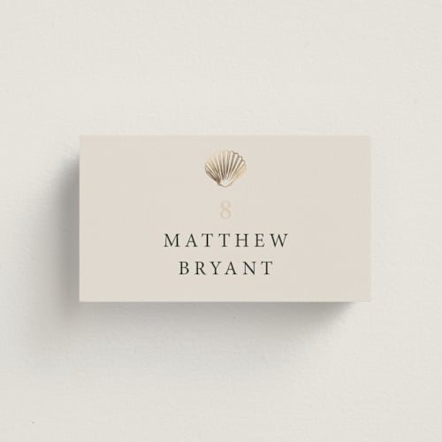 This is a sand wedding place cards with foil pressed by Hannah Bowman called simple seashell printing on signature in placecard
