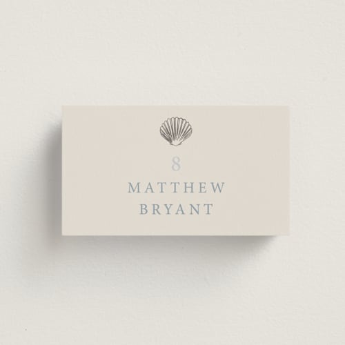 This is a sea spray wedding place cards with foil pressed by Hannah Bowman called simple seashell printing on signature in placecard