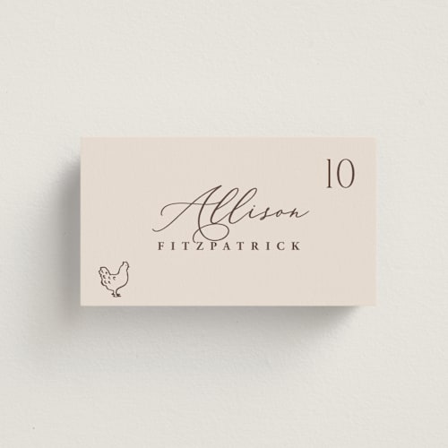 This is a ecru wedding place cards with standard by Hooray Creative called chic script printing on signature in placecard