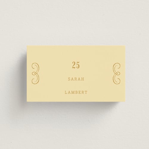 This is a butter wedding place cards with standard by Nazia Hyder called vintage label printing on signature in placecard