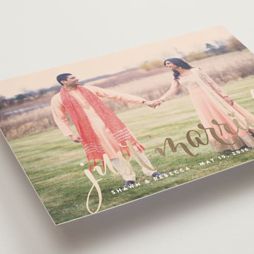 This is a gold wedding announcements with foil pressed by Annie Clark called aglow printing on recycled smooth signature in standard