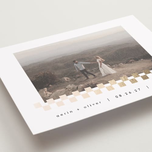 This is a snow foil stamped save the date cards with foil pressed by AK Graphics called checkered printing on recycled smooth signature in standard