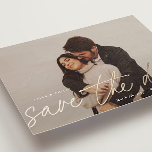 This is a snow foil stamped save the date cards with foil pressed by Sara Hicks Malone called scripted printing on recycled smooth signature in standard