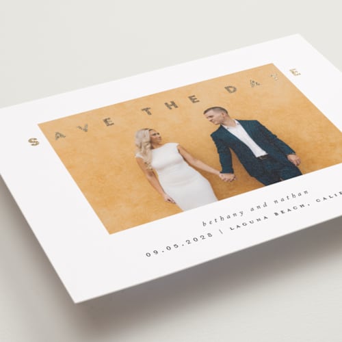 This is a porcelain foil stamped save the date cards with foil pressed by Stacy Maalouf called gilded simplicity printing on recycled smooth signature in standard