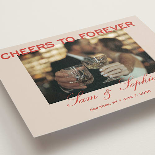This is a tomato petite save the dates with standard by Sydney Kay called bold cheers printing on recycled smooth signature in petite