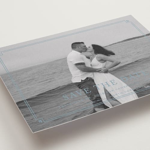 This is a french blue petite save the dates with standard by Carolyn MacLaren called fleur corner printing on recycled smooth signature in petite