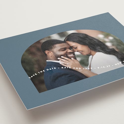 This is a dusty blue save the date postcards with standard by Leah Ragain called wavy arch printing on signature in postcard