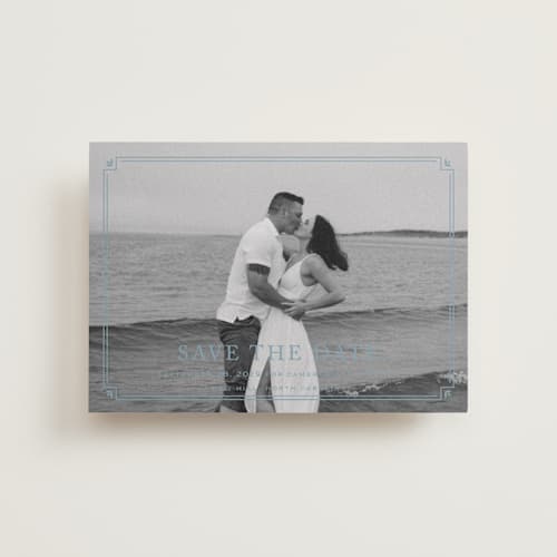 This is a french blue petite save the dates with standard by Carolyn MacLaren called fleur corner printing on recycled smooth signature in petite