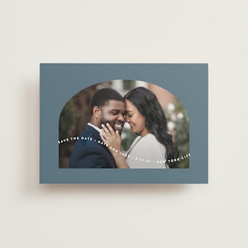 This is a dusty blue save the date postcards with standard by Leah Ragain called wavy arch printing on signature in postcard