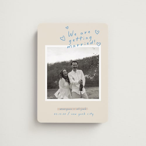 This is a light blue save the date magnets with standard by Pati Cascino called surprise! printing on magnet paper in magnet