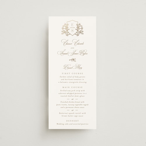 This is a ivory menu cards with foil pressed by Mansi Verma called gold crest printing on signature in 4x9