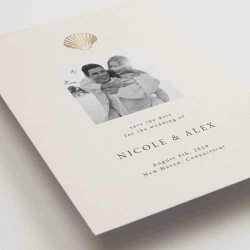 This is a sand foil stamped save the date cards with foil pressed by Hannah Bowman called simple seashell printing on recycled smooth signature in standard