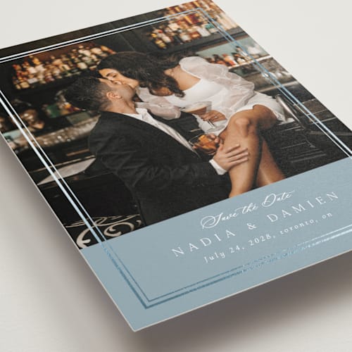 This is a slate blue foil stamped save the date cards with foil pressed by Nicole Walsh called shimmer printing on recycled smooth signature in standard