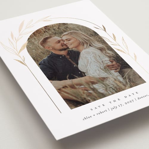 This is a silk foil stamped save the date cards with foil pressed by Kelly Schmidt called botanical arches printing on recycled smooth signature in standard