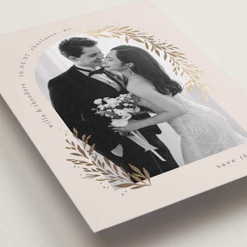 This is a linen foil stamped save the date cards with foil pressed by Laura Hankins called garland arch printing on recycled smooth signature in standard