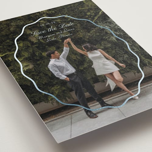 This is a periwinkle foil stamped save the date cards with foil pressed by Baumbirdy called scallop frame printing on recycled smooth signature in standard