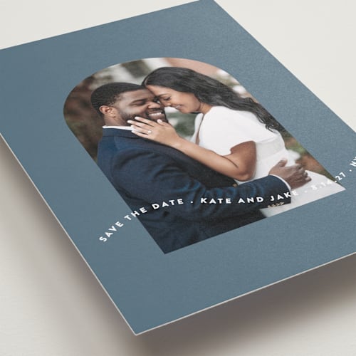 This is a dusty blue save the date with standard by Leah Ragain called wavy arch printing on recycled smooth signature in standard