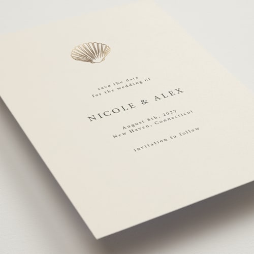 This is a sand foil stamped save the date cards with foil pressed by Hannah Bowman called simple seashell printing on signature in 5x7